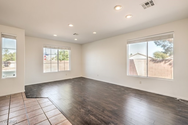 empty room with dark hardwood / wood-style flooring