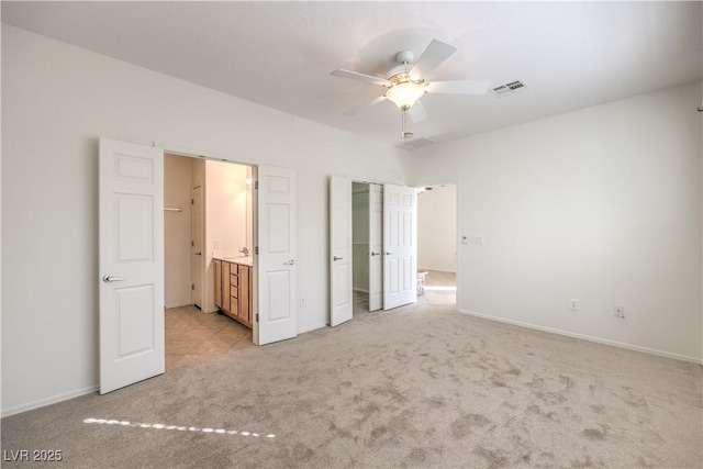 unfurnished bedroom with light colored carpet and ceiling fan