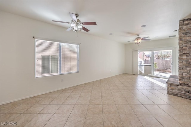 spare room with light tile patterned floors and ceiling fan