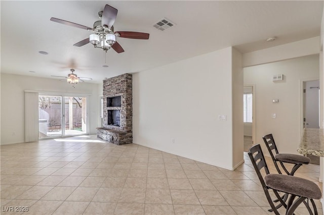 unfurnished living room with light tile patterned flooring and a fireplace