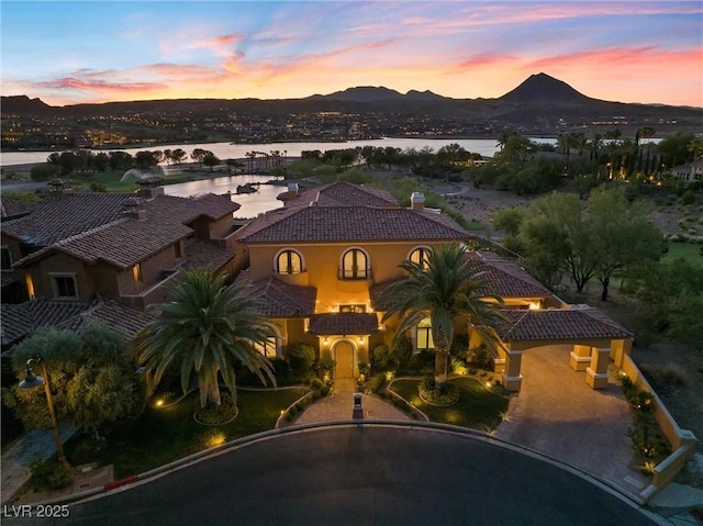 mediterranean / spanish home featuring a water and mountain view