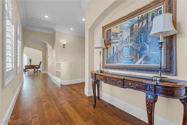 hall with ornamental molding and dark wood-type flooring