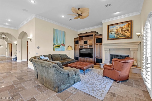 living room featuring ornamental molding and ceiling fan