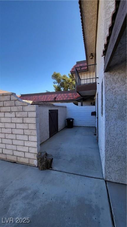 view of side of home with a patio area