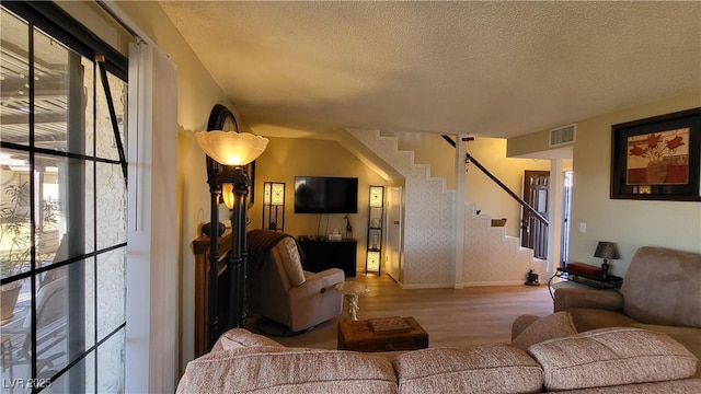 living room featuring hardwood / wood-style flooring and a textured ceiling