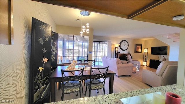 dining space with light hardwood / wood-style floors