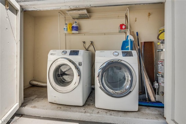 clothes washing area featuring washer and clothes dryer