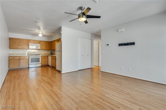 kitchen with ceiling fan, light wood-type flooring, white appliances, and decorative backsplash