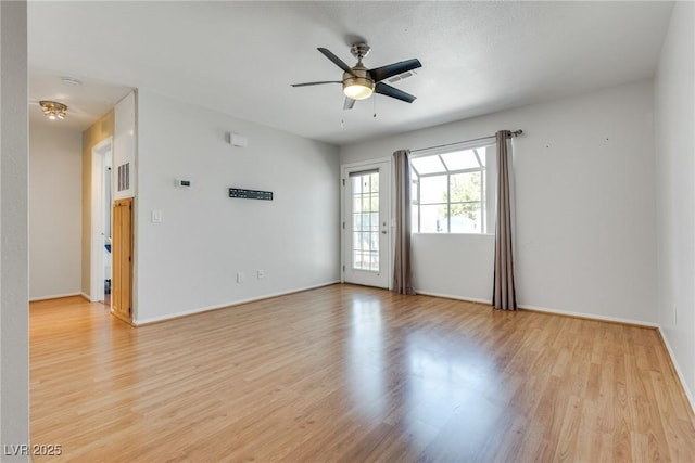 spare room featuring light hardwood / wood-style flooring and ceiling fan