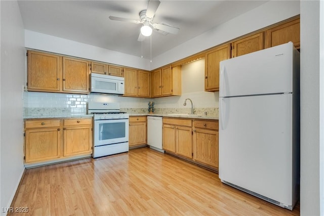 kitchen featuring decorative backsplash, white appliances, sink, and light hardwood / wood-style flooring