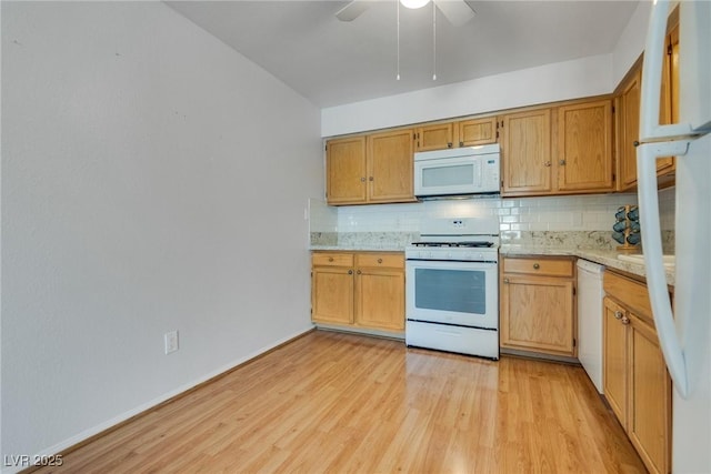 kitchen featuring white appliances, ceiling fan, light stone counters, light hardwood / wood-style floors, and decorative backsplash