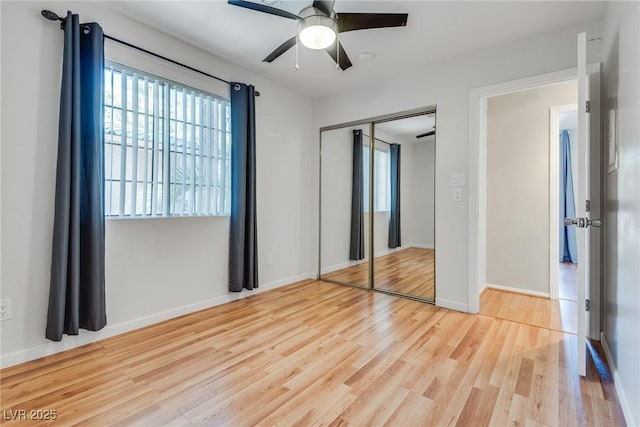 unfurnished bedroom with a closet, ceiling fan, and light wood-type flooring