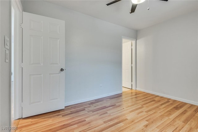 empty room with ceiling fan and light hardwood / wood-style floors