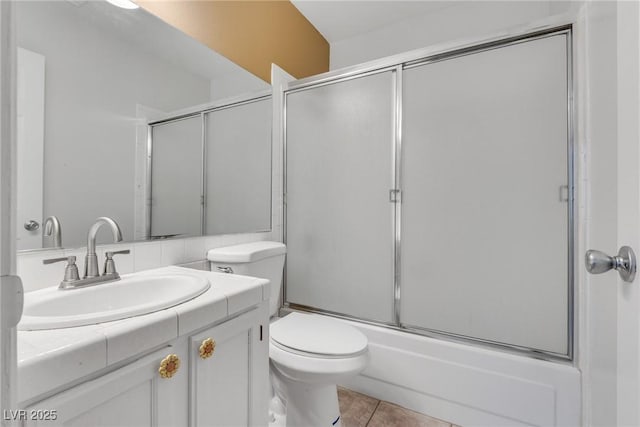 full bathroom with vanity, tile patterned floors, shower / bath combination with glass door, and toilet