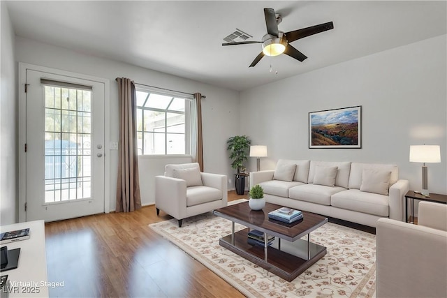 living room featuring ceiling fan and light wood-type flooring