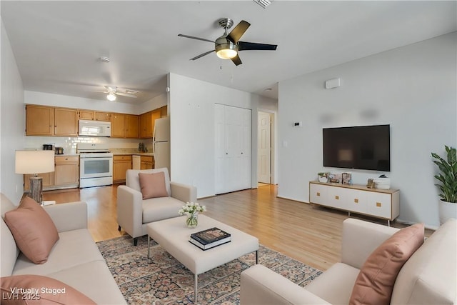 living room with ceiling fan and light wood-type flooring