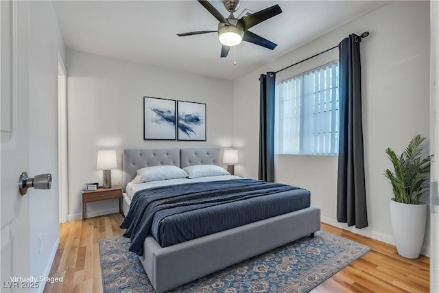 bedroom with wood-type flooring and ceiling fan