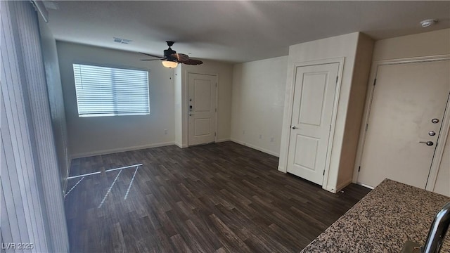 spare room featuring ceiling fan and dark hardwood / wood-style floors