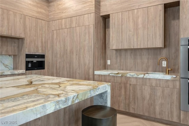 kitchen featuring light brown cabinetry and sink