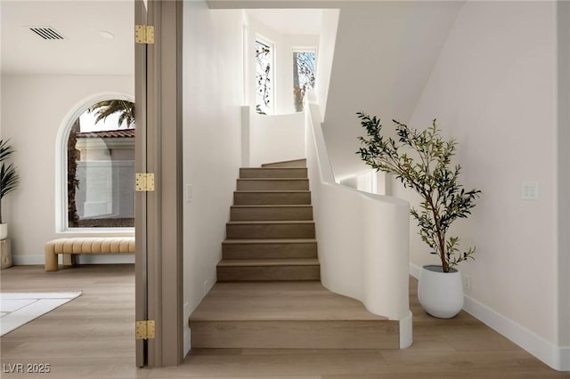 staircase featuring hardwood / wood-style floors