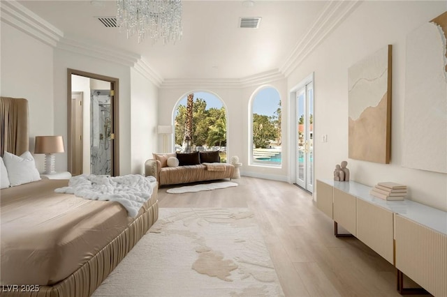 bedroom featuring ensuite bath, a notable chandelier, ornamental molding, access to outside, and light wood-type flooring