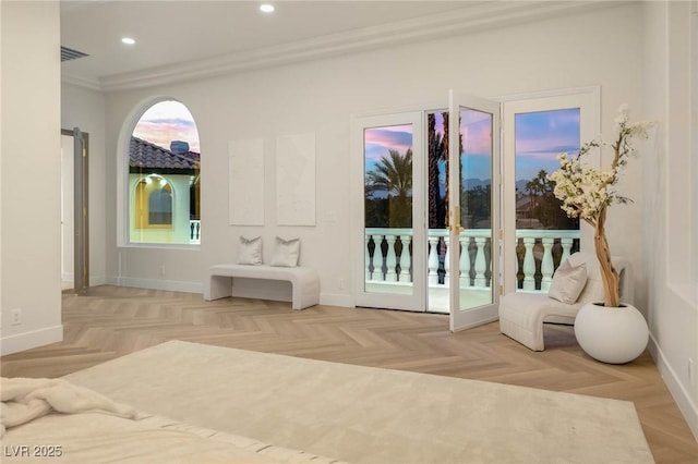 bedroom with crown molding, light parquet flooring, and access to outside