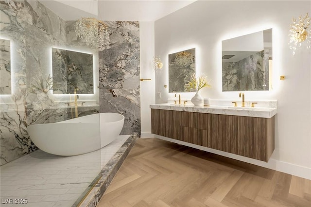 bathroom with vanity, parquet floors, and a tub to relax in