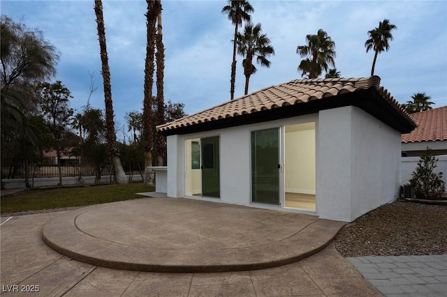 74 Innisbrook Ave, Las Vegas, NV 89113 - rear view of house featuring a patio area, a tile roof, stucco siding, and fence