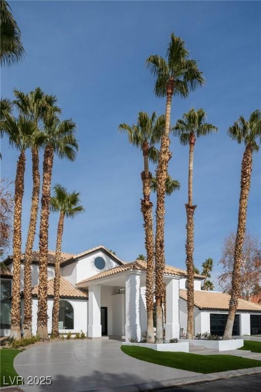 74 Innisbrook Ave, Las Vegas, NV 89113 - mediterranean / spanish house featuring a tile roof and stucco siding