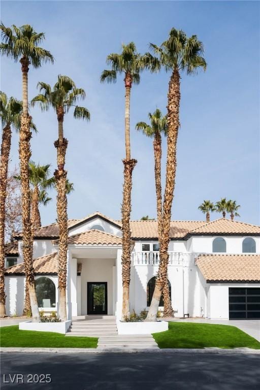 74 Innisbrook Ave, Las Vegas, NV 89113 - mediterranean / spanish house with stucco siding, a tile roof, and a front lawn