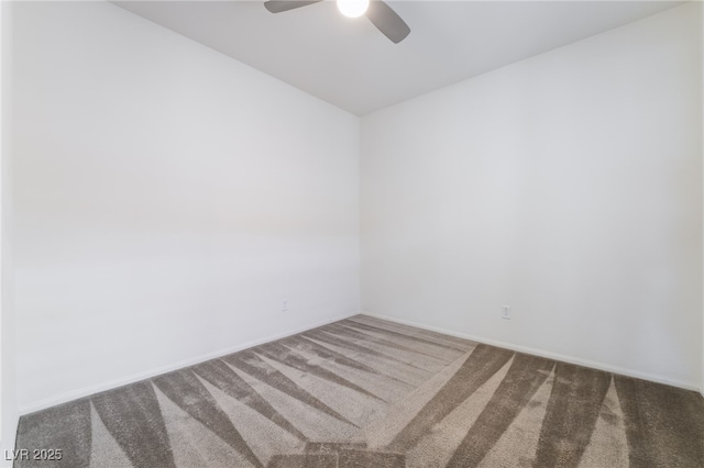 carpeted empty room featuring a ceiling fan and baseboards