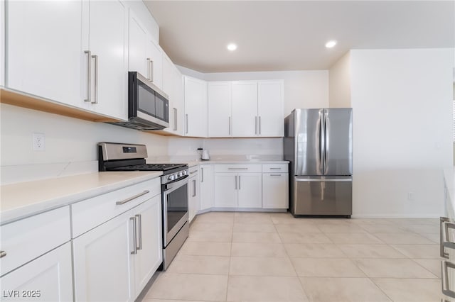 kitchen featuring white cabinetry, stainless steel appliances, and light countertops