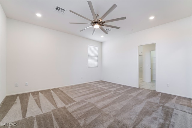 spare room featuring a ceiling fan, recessed lighting, visible vents, and light colored carpet