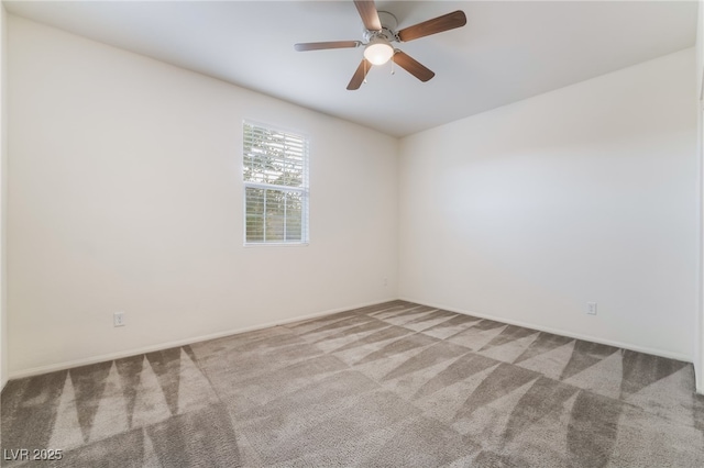 spare room with ceiling fan and light colored carpet