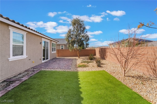 view of yard with a fenced backyard and a patio