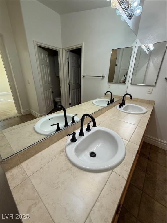 full bath featuring double vanity and a sink