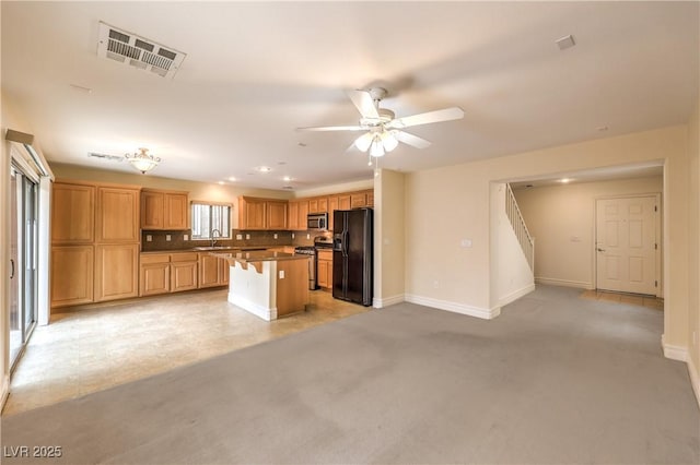 kitchen with open floor plan, stainless steel appliances, a sink, and visible vents