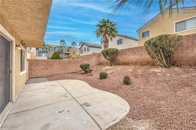 view of patio featuring a fenced backyard and a residential view