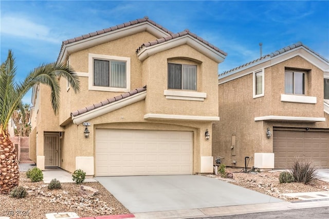 view of front of property with a garage, concrete driveway, a tile roof, and stucco siding