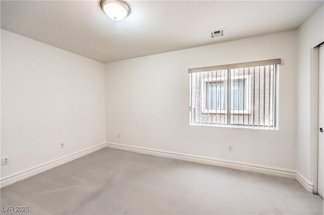 empty room with visible vents and baseboards