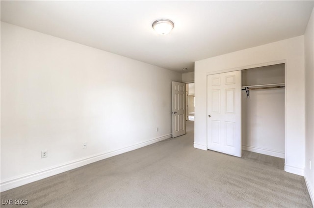 unfurnished bedroom featuring a closet, carpet, and baseboards