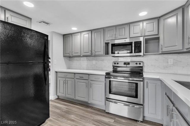 kitchen with light countertops, appliances with stainless steel finishes, and gray cabinets