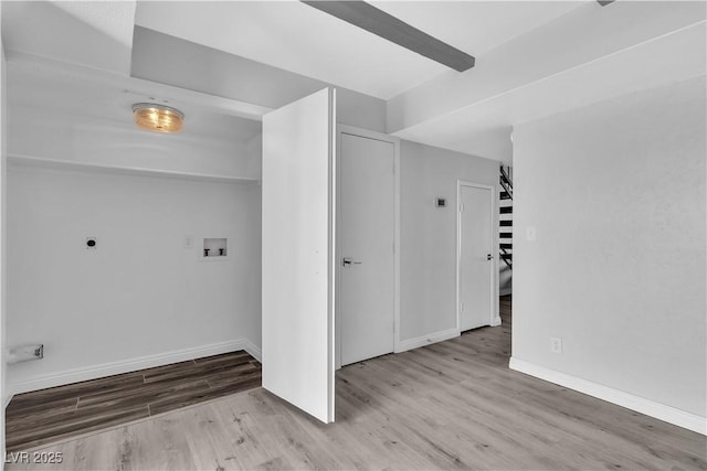 washroom featuring light wood-style flooring, washer hookup, electric dryer hookup, and baseboards