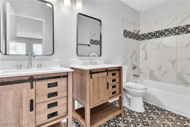 bathroom featuring shower / tub combination, two vanities, a sink, and toilet