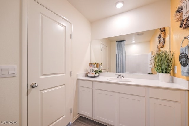 bathroom featuring vanity and hardwood / wood-style flooring