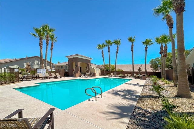 pool featuring a patio area and fence