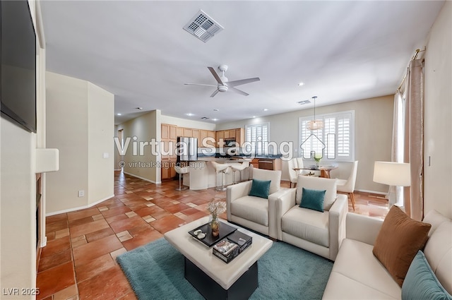 living room with light tile patterned floors, baseboards, visible vents, ceiling fan, and recessed lighting