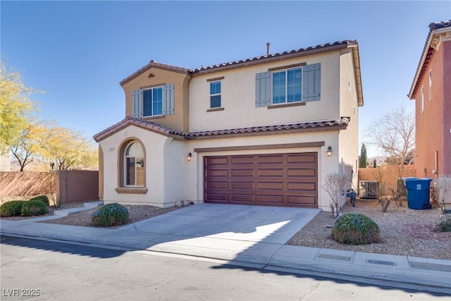 mediterranean / spanish house featuring a garage and central AC