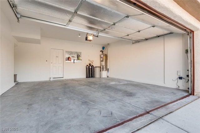 garage featuring a garage door opener and strapped water heater