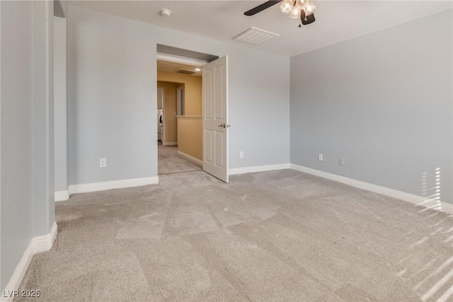 carpeted spare room with ceiling fan